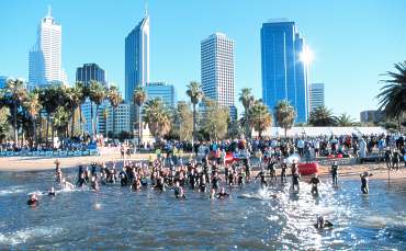 The sparkling Perth skyline overlooks the age group swim start.